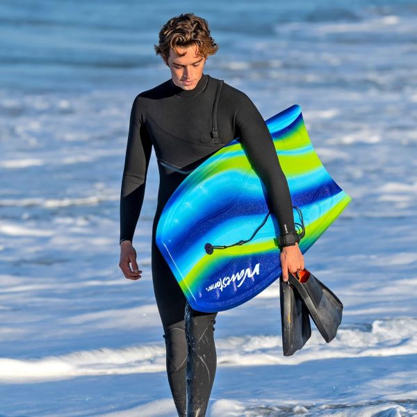 man carrying a bodyboard walking out of the surfing scene