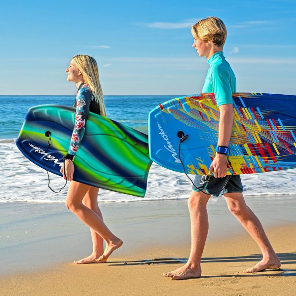 kids carrying their bodyboards into the ocean