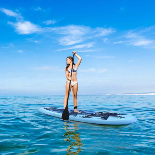 woman using a paddle board in the middle of the ocean
